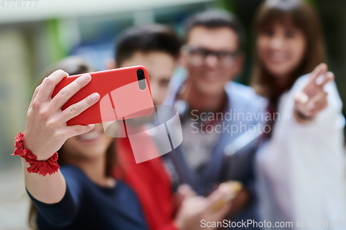 Image of Group of multiethnic teenagers taking a selfie in school