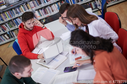 Image of students group working on school project together on tablet computer at modern university