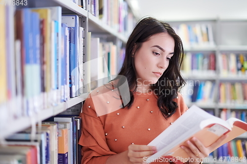 Image of the student uses a notebook and a school library