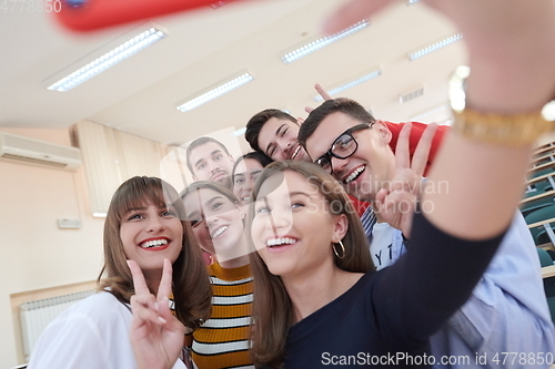 Image of Group of multiethnic teenagers taking a selfie in school