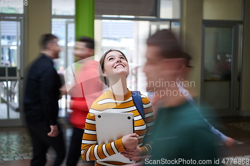 Image of famel student with modern technology in school