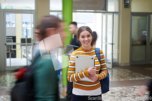 Image of famel student with modern technology in school