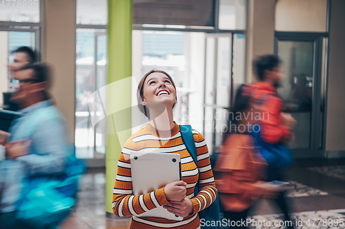 Image of famel student with modern technology in school