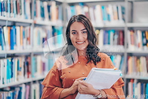 Image of the student uses a notebook and a school library