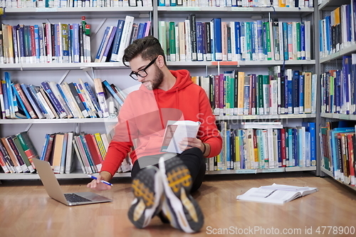 Image of the students uses a notebook, laptop and a school library