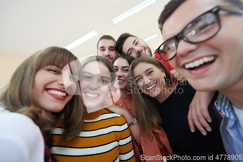 Image of Group of multiethnic teenagers taking a selfie in school