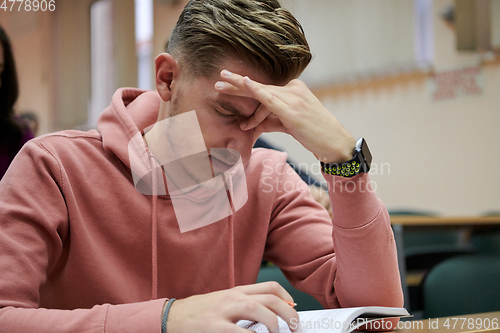 Image of the student has a headache in class