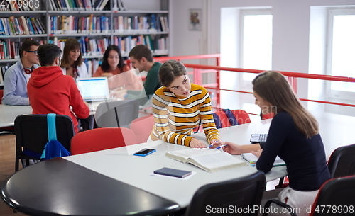 Image of students group working on school project together on tablet computer at modern university