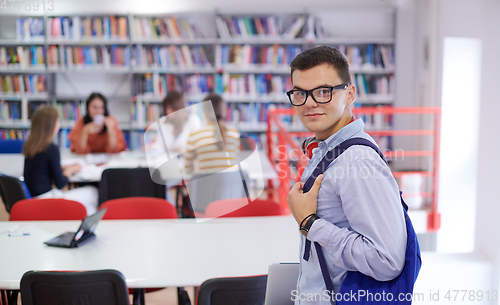 Image of the student uses a notebook, latop and a school library