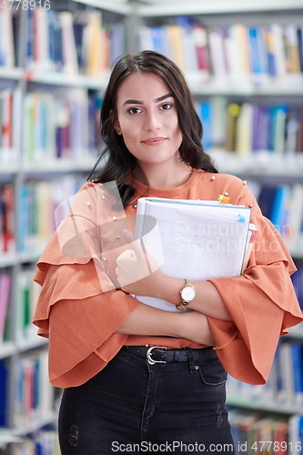 Image of the student uses a notebook and a school library