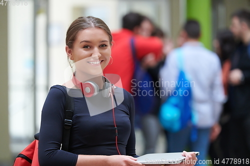 Image of famel student with modern technology in school