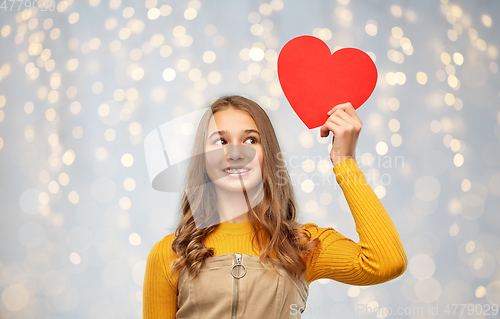 Image of smiling teenage girl with red heart