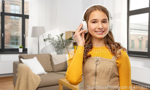 Image of teenage girl in headphones listening to music