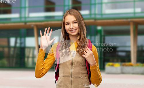 Image of teenage student girl with backpack over school