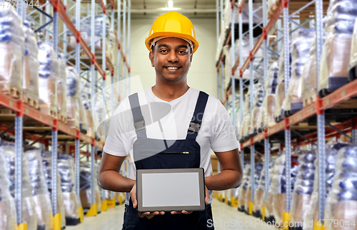 Image of happy indian worker with tablet pc at warehouse