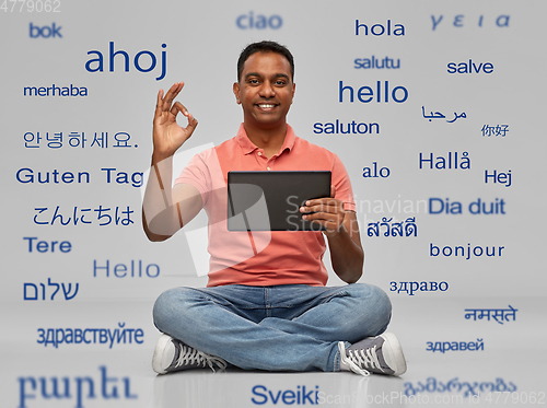 Image of happy indian man with tablet pc