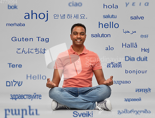 Image of happy indian man over words in foreign languages