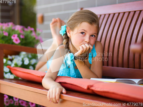 Image of Little girl is reading a book