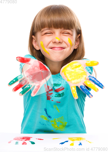 Image of Portrait of a cute girl playing with paints