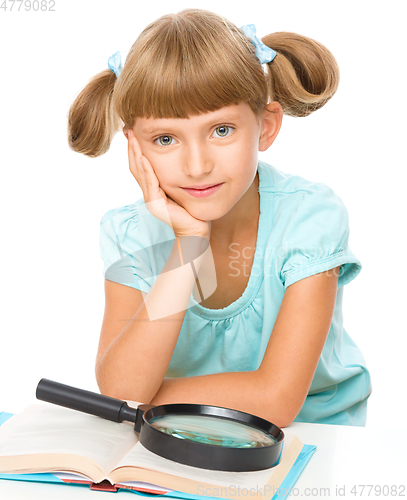 Image of Little girl is reading book