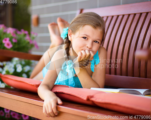 Image of Little girl is reading a book