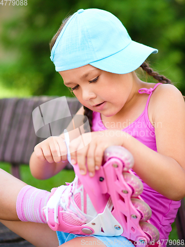 Image of Little girl is wearing roller-blades
