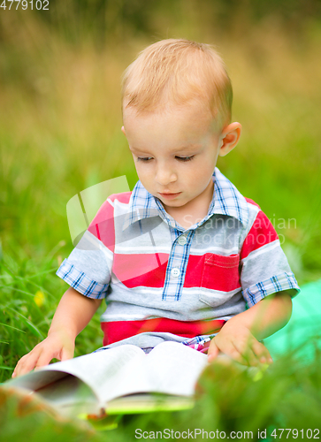 Image of Little boy is reading book