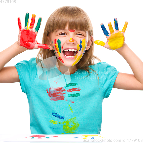 Image of Portrait of a cute girl playing with paints