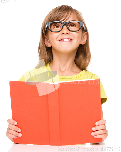 Image of Little girl is reading a book