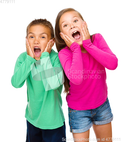 Image of Little girl and boy are holding their faces