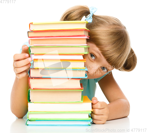 Image of Little girl plays with book