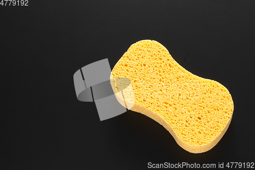 Image of yellow sponge isolated on black background