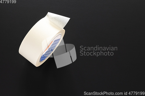 Image of painters adhesive roll isolated on black background