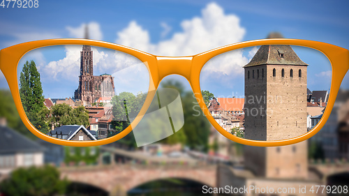 Image of orange glasses sharp and blurred Strasbourg scenery