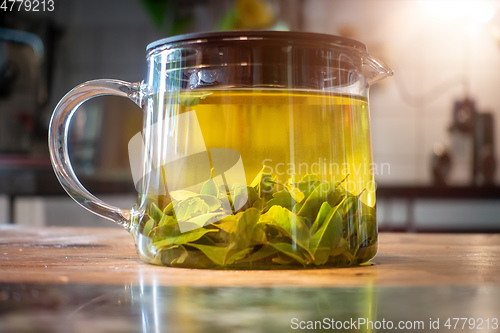 Image of pot of verbena tea on old wooden table