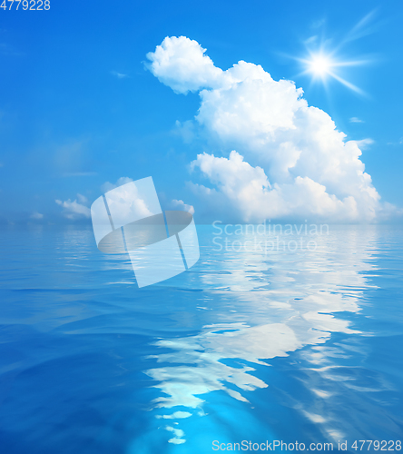 Image of blue sky with white clouds and sun over the sea