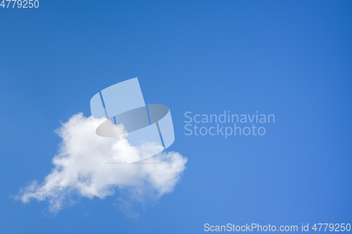 Image of single cloud in the blue sky background