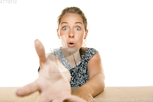 Image of Young woman opening the biggest postal package isolated on white