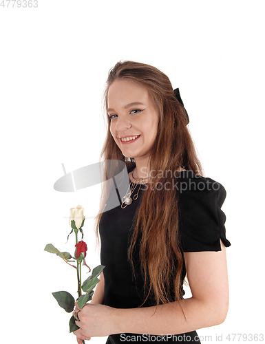 Image of Lovely woman in bla+D1:J49ck dress holding roses