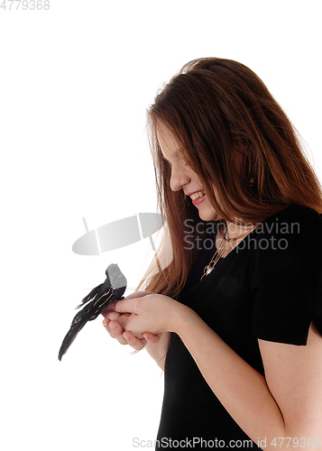 Image of Woman holding a fake bird in her hands