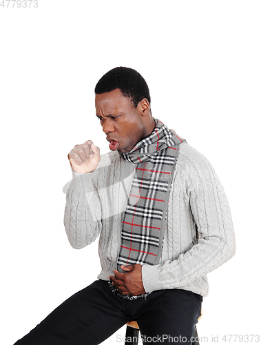 Image of Coughing young man sitting with scarf