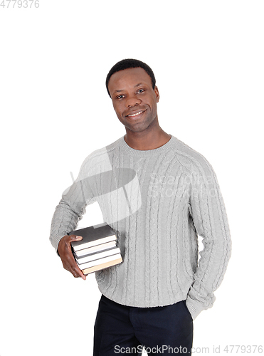 Image of African man standing with books under his arms