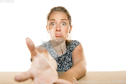 Image of Young woman opening the biggest postal package isolated on white