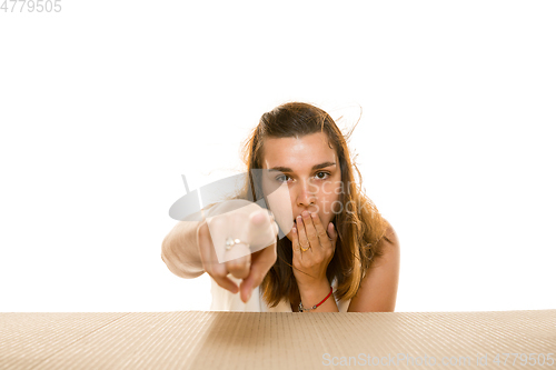 Image of Young woman opening the biggest postal package isolated on white