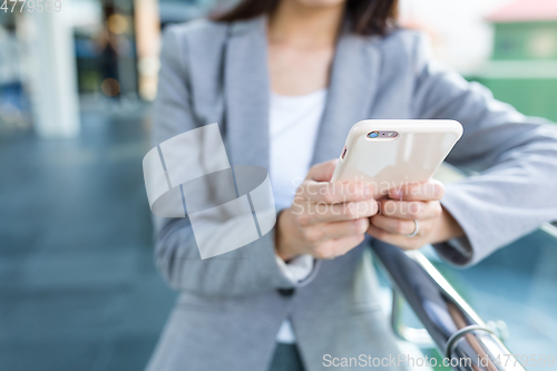 Image of Businesswoman using mobile phone at outdoor