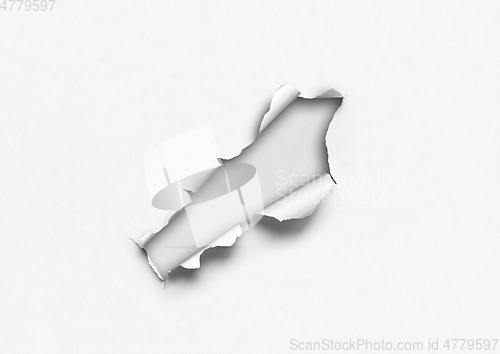 Image of White torn paper with hole