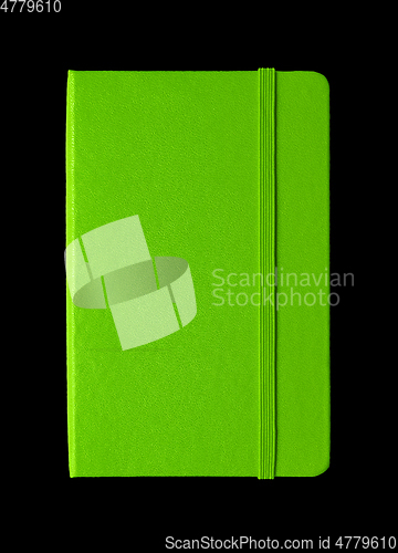 Image of Green closed notebook isolated on black