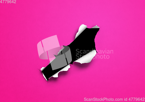 Image of Pink torn paper with black hole