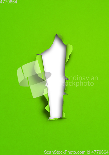 Image of Green torn paper with hole