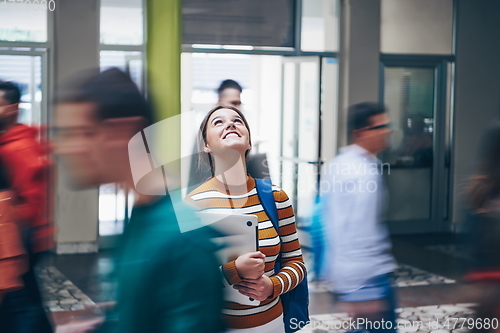 Image of famel student with modern technology in school